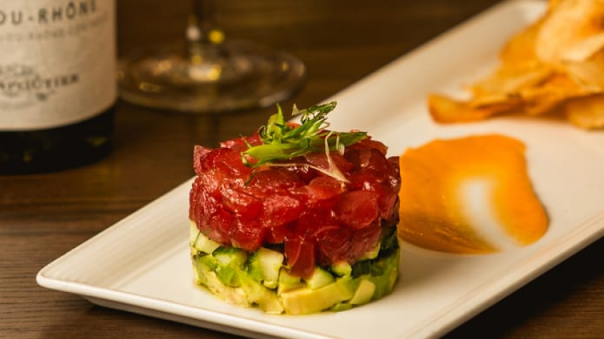 Plate of food featuring salmon tartare and avocado