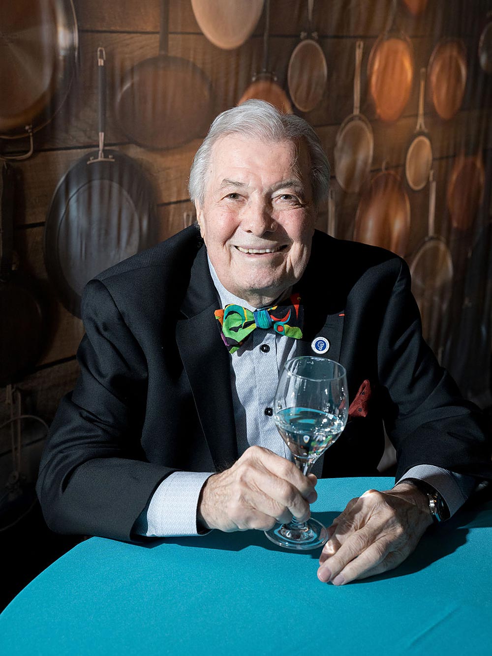 Jacques Pépin holding a glass of wine