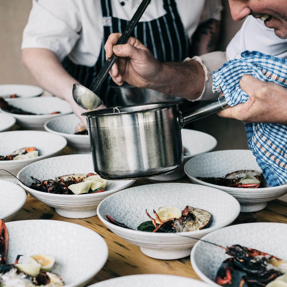 Chefs serving lobsters in a restaurant. Photo by Rachel Claire on Pexels